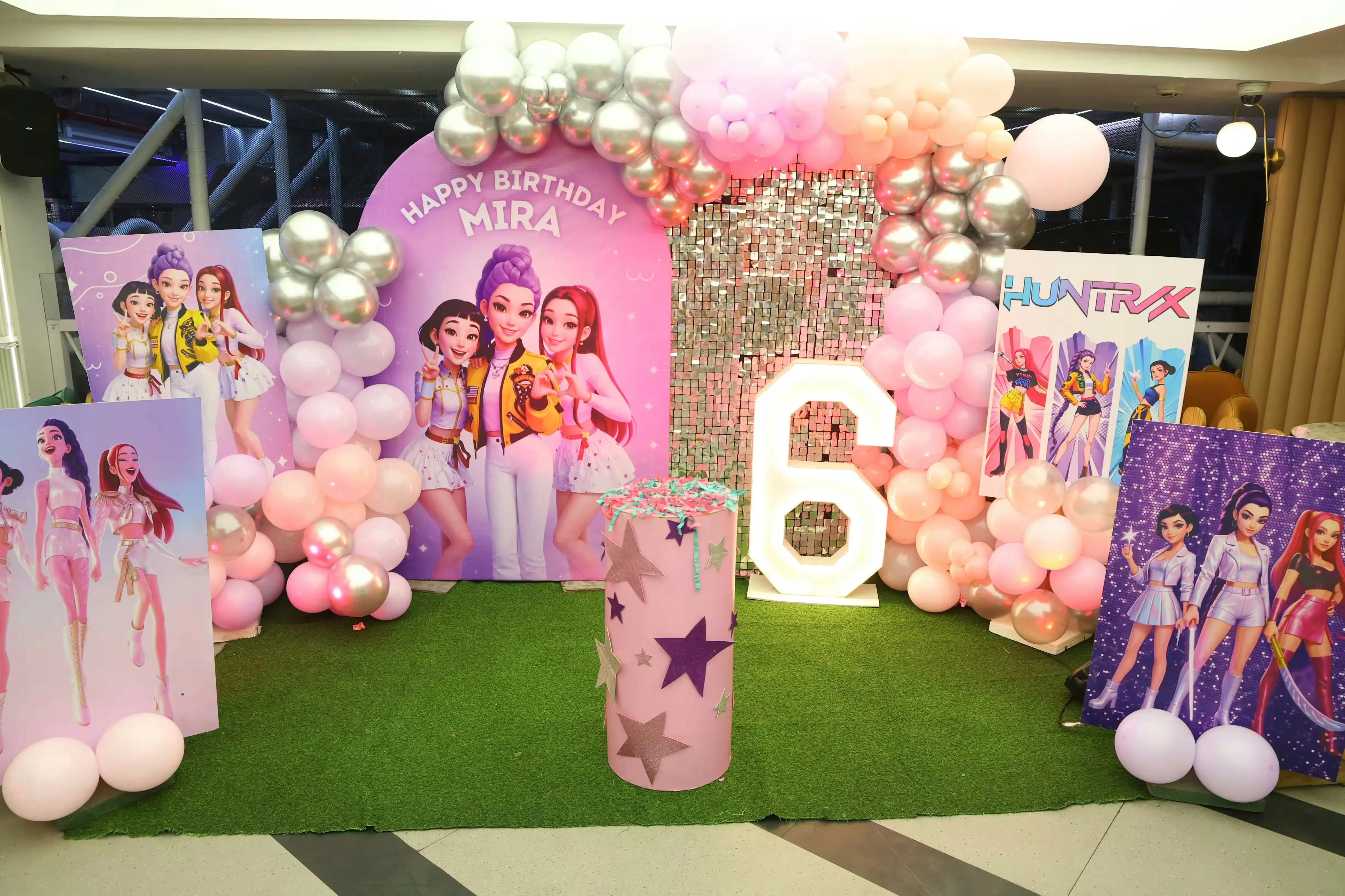A colourful balloon backdrop styled for a birthday celebration