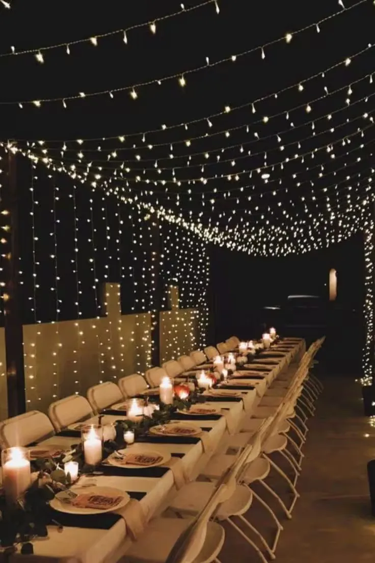 Fairy lights strung vertically to form a glowing backdrop