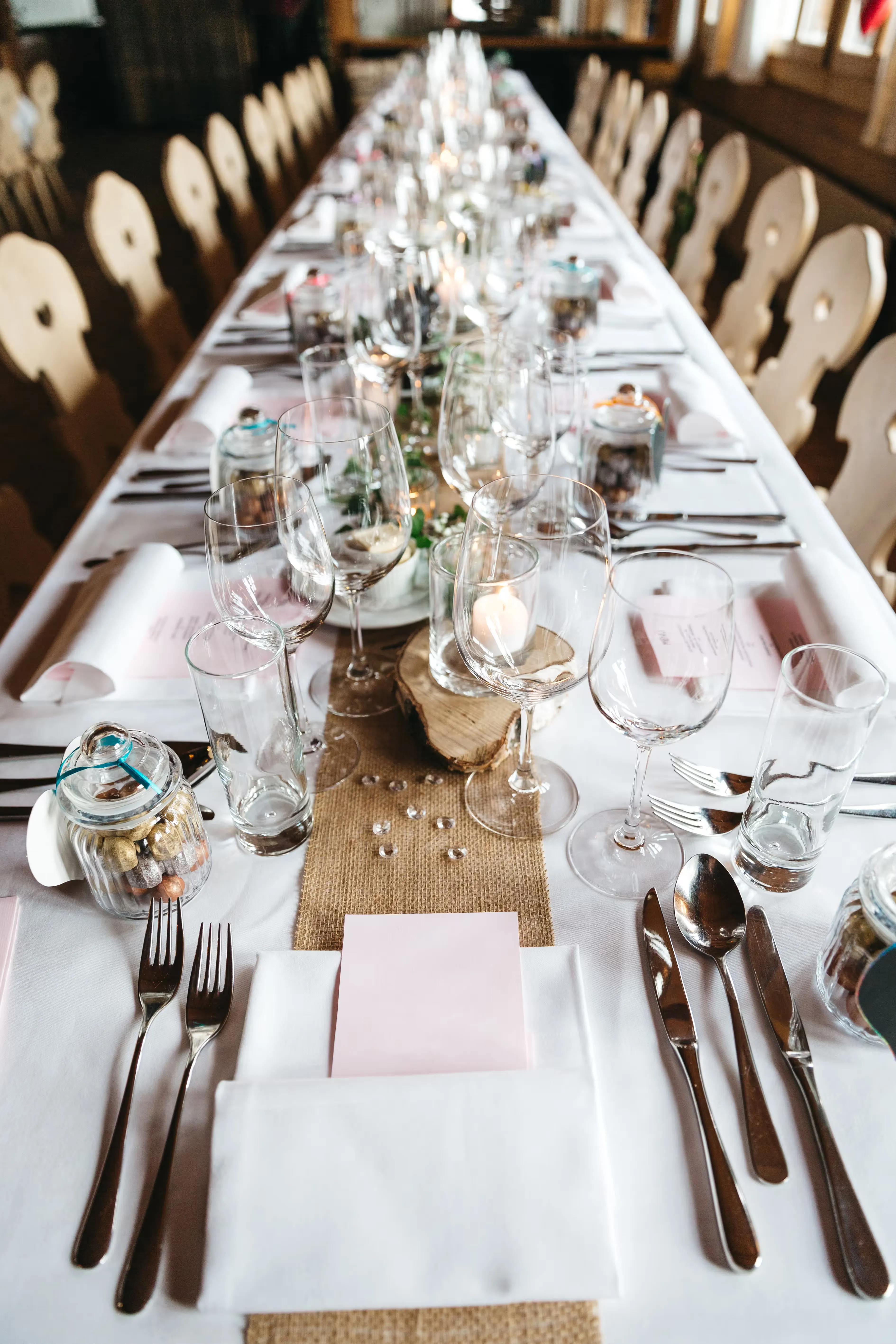 A tall table setting shown from above, showing the runner and centrepiece detail